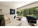 Bright living room features a large window, a modern sectional sofa, and elegant decor for a comfortable atmosphere at 1242 Wild Creek Ne Trl, Atlanta, GA 30324
