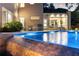 Beautiful pool with outdoor kitchen, dining area, and large windows offering seamless indoor/outdoor living at 1242 Wild Creek Ne Trl, Atlanta, GA 30324