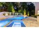 Backyard pool featuring a jacuzzi and elegant landscape lighting at 1242 Wild Creek Ne Trl, Atlanta, GA 30324