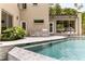 Beautiful pool with outdoor kitchen, dining area, and large windows offering seamless indoor/outdoor living at 1242 Wild Creek Ne Trl, Atlanta, GA 30324