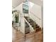 Staircase featuring hardwood floors, glass railings, and bright natural light at 1242 Wild Creek Ne Trl, Atlanta, GA 30324