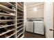 Organized walk-in closet with custom shelving for shoes and ample storage with new washer and dryer at 1242 Wild Creek Ne Trl, Atlanta, GA 30324
