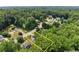 An aerial view of a property with mature trees, highlighting the approximate property lines at 130 Timber Oak Cv, Lawrenceville, GA 30043