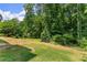 Sprawling backyard with partially fenced in yard and mature trees at 130 Timber Oak Cv, Lawrenceville, GA 30043