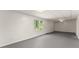 Unfinished basement area with finished ceiling, floors, and natural light from the window at 130 Timber Oak Cv, Lawrenceville, GA 30043