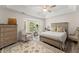 Serene bedroom with a tray ceiling, bay window, and neutral decor at 130 Timber Oak Cv, Lawrenceville, GA 30043