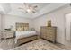 Spacious bedroom boasts luxury vinyl plank flooring, trey ceilings, and a ceiling fan at 130 Timber Oak Cv, Lawrenceville, GA 30043