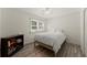 Cozy bedroom with light gray luxury vinyl plank flooring, a window, and a book shelf at 130 Timber Oak Cv, Lawrenceville, GA 30043