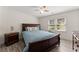 Comfortable bedroom with luxury vinyl plank flooring, a ceiling fan, and a large window at 130 Timber Oak Cv, Lawrenceville, GA 30043