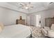 Bright bedroom with luxury vinyl plank flooring, trey ceilings, and an attached bathroom at 130 Timber Oak Cv, Lawrenceville, GA 30043