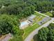 Aerial shot of a community pool, tennis court, parking lot, and playground surrounded by trees at 130 Timber Oak Cv, Lawrenceville, GA 30043
