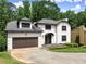 Elegant two-story home featuring a manicured lawn, a driveway and a two-car garage at 130 Timber Oak Cv, Lawrenceville, GA 30043