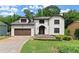 A front exterior view of a two-story home with a well-manicured lawn and an attached garage at 130 Timber Oak Cv, Lawrenceville, GA 30043