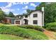 Charming two-story home featuring a manicured lawn, front garden and a two-car garage at 130 Timber Oak Cv, Lawrenceville, GA 30043