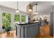Modern kitchen with granite countertops, stainless steel appliances, and a wine cooler at 130 Timber Oak Cv, Lawrenceville, GA 30043