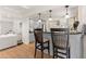 Kitchen bar area with light gray cabinets, dark countertop and two dark-stained wooden bar stools at 130 Timber Oak Cv, Lawrenceville, GA 30043
