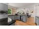 Kitchen area featuring an eat-in area with stainless appliances, gray cabinets and a wine fridge at 130 Timber Oak Cv, Lawrenceville, GA 30043