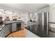 An open kitchen area with stainless steel appliances and an adjacent dining area and living room at 130 Timber Oak Cv, Lawrenceville, GA 30043