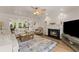 Bright living room with a fireplace, decorative rug, and ample seating at 130 Timber Oak Cv, Lawrenceville, GA 30043