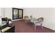 Cozy outdoor patio area with seating and black framed glass doors leading inside at 130 Timber Oak Cv, Lawrenceville, GA 30043
