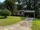 Quaint brick home with a green lawn, mature trees, and a covered front entrance at 186 W Lake Nw Dr, Atlanta, GA 30314