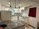 Bright kitchen featuring granite countertops, white cabinets, and modern lighting fixtures at 186 W Lake Nw Dr, Atlanta, GA 30314