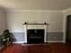 Living room highlighting the fireplace with mantel, hardwood flooring, and decorative moldings at 186 W Lake Nw Dr, Atlanta, GA 30314