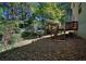 Backyard featuring a multi-tiered deck, lush lawn, and mature trees providing ample shade at 2066 Tidwell Trl, Stone Mountain, GA 30088