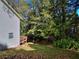 Backyard featuring a lush lawn, mature trees, and access ramp at 2066 Tidwell Trl, Stone Mountain, GA 30088