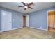 Bedroom with ceiling fan, carpeted floors, and access to bathroom at 2066 Tidwell Trl, Stone Mountain, GA 30088