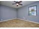 Comfortable bedroom with carpet, natural light, and a ceiling fan at 2066 Tidwell Trl, Stone Mountain, GA 30088