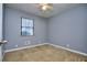 Cozy bedroom featuring neutral carpet, and a ceiling fan for added comfort at 2066 Tidwell Trl, Stone Mountain, GA 30088