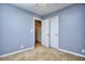 Comfortable carpeted bedroom with a closet and access to the adjacent room at 2066 Tidwell Trl, Stone Mountain, GA 30088
