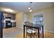 Kitchen with gray cabinets, stainless steel appliances, and breakfast table at 2066 Tidwell Trl, Stone Mountain, GA 30088