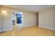 Bright living room adjacent to the dining area, featuring hardwood floors and neutral-colored walls at 2066 Tidwell Trl, Stone Mountain, GA 30088