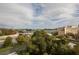 Scenic aerial view of surrounding buildings and trees under a blue, cloudy sky at 215 Piedmont Ne Ave # 804, Atlanta, GA 30308