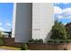 Low angle of high rise building with brick facade and a well maintained front landscape at 215 Piedmont Ne Ave # 804, Atlanta, GA 30308