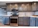 Modern kitchen featuring stainless steel appliances, light countertops and gray cabinets at 215 Piedmont Ne Ave # 804, Atlanta, GA 30308