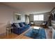 Cozy living room featuring a blue couch, wood floors, a mirror, and comfortable seating at 215 Piedmont Ne Ave # 804, Atlanta, GA 30308