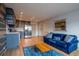 Open living area featuring a blue couch, stainless steel kitchen, and wood floors at 215 Piedmont Ne Ave # 804, Atlanta, GA 30308