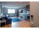 Open living area featuring a blue couch, stainless steel kitchen, and wood floors at 215 Piedmont Ne Ave # 804, Atlanta, GA 30308