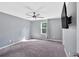 Bedroom with carpet, ceiling fan, and mounted TV, bathed in natural light from a window at 3 Windsor Ct, Kingston, GA 30145