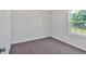 The cozy bedroom with a plush carpet and natural light streaming in through the window at 3 Windsor Ct, Kingston, GA 30145