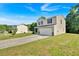 The home features a lush green lawn and a two car garage at 3 Windsor Ct, Kingston, GA 30145