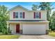 Charming two-story home featuring red shutters, a covered porch, and an attached two-car garage at 3 Windsor Ct, Kingston, GA 30145