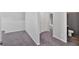 Neutral hallway space leading to a bathroom, carpeted and well-lit at 3 Windsor Ct, Kingston, GA 30145