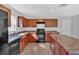 The spacious kitchen features wood cabinets, an island, and modern appliances at 3 Windsor Ct, Kingston, GA 30145