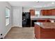 The spacious kitchen features wood cabinets, an island, and modern appliances at 3 Windsor Ct, Kingston, GA 30145