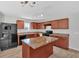 The spacious kitchen features wood cabinets, an island, and modern appliances at 3 Windsor Ct, Kingston, GA 30145