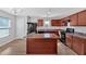 The spacious kitchen features wood cabinets, an island, and modern appliances at 3 Windsor Ct, Kingston, GA 30145